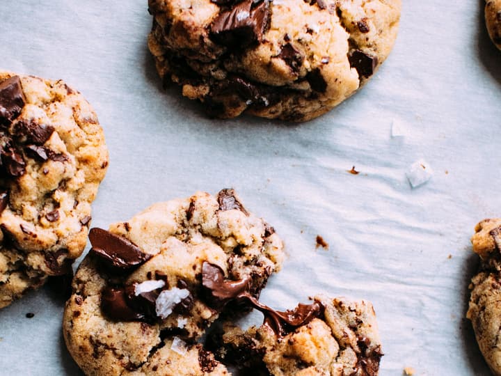 Chocolate chip cookies cooling on baking paper